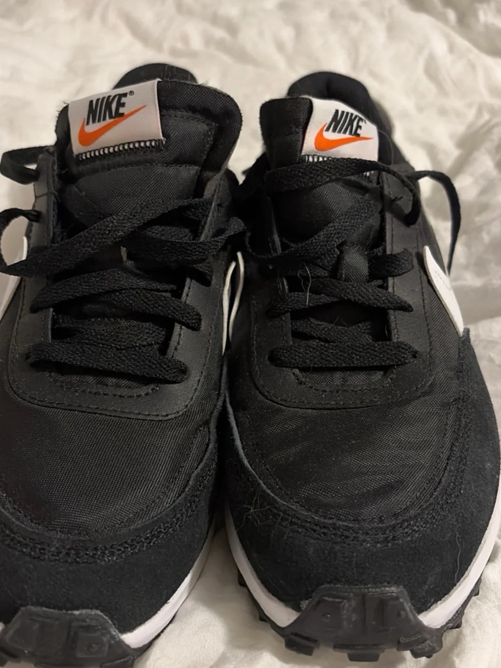 Nike Black Sneakers with White Swoosh and Orange Logo